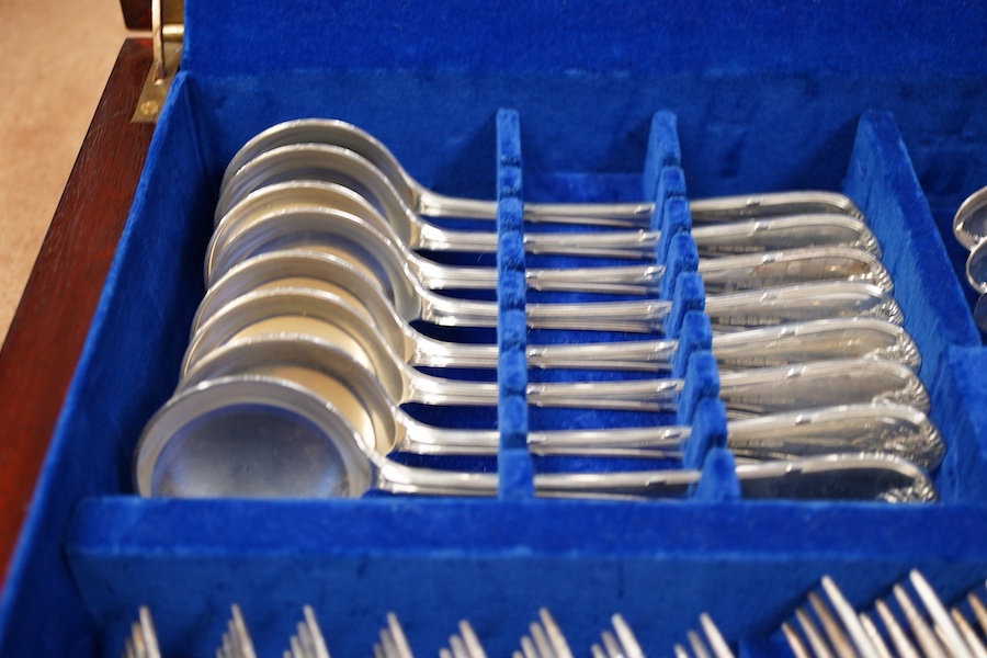 An Elizabeth II canteen of silver cutlery for eight, by Mappin & Webb, comprising table and dessert forks, dessert, soup and teaspoons, silver handled steel table and dessert knives two table or serving spoons and a pair